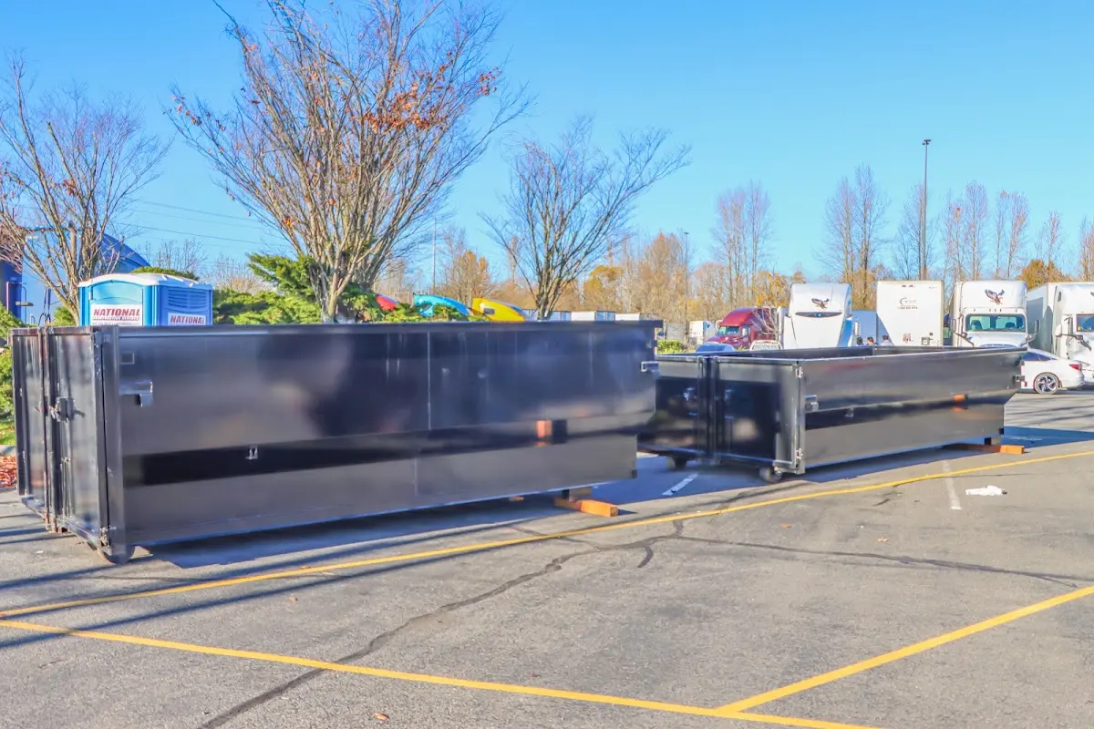 Professional dumpster rental service with roll-off container on residential driveway in Almena